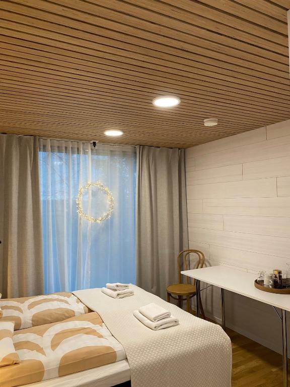 a bedroom with a bed and a window with a wreath at HALLA-mökki in Tyrnävä