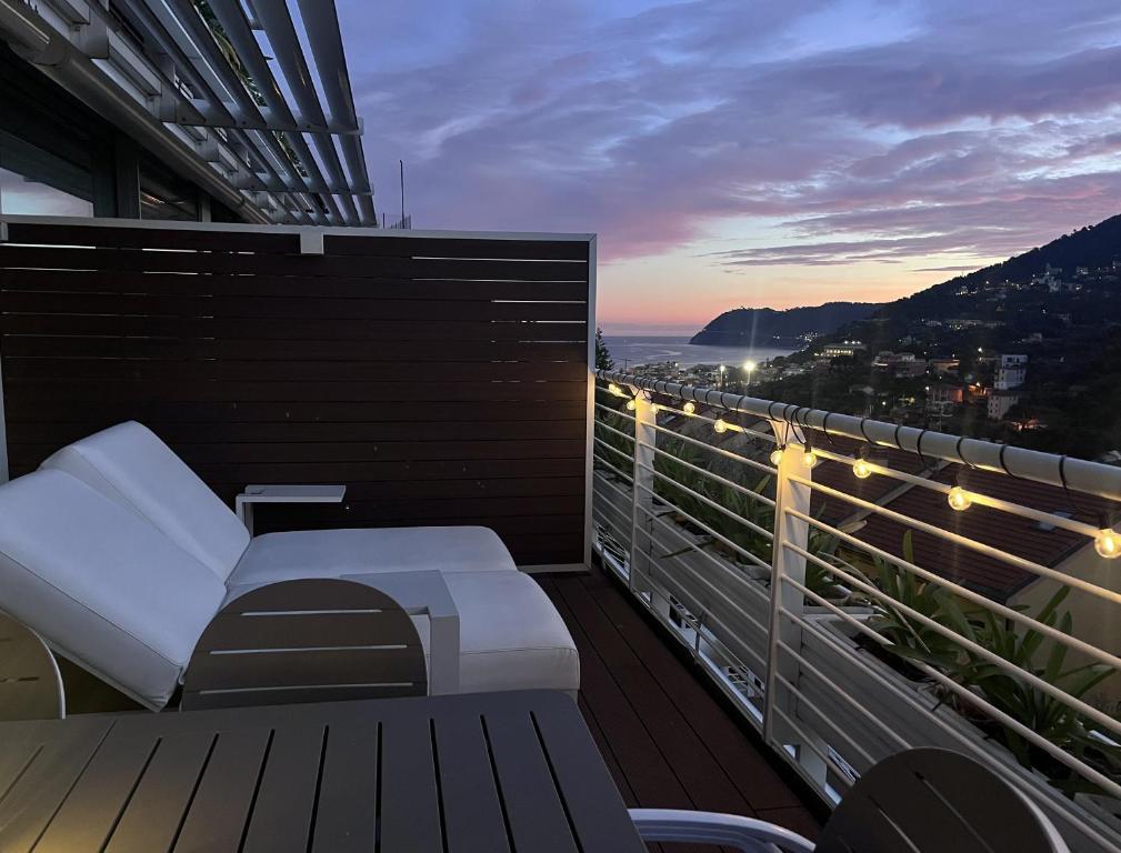 a balcony with a bench and a view of the ocean at A House with a view in Alassio