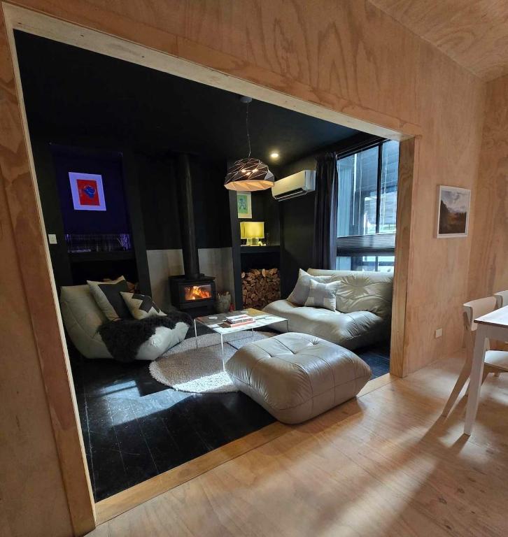 a living room with a couch and a table at Nordic Noir Cabin in Queenstown