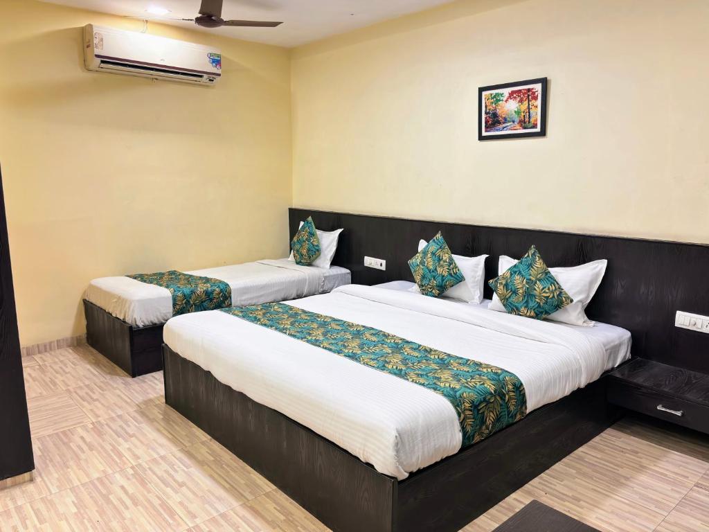 a bedroom with two beds in a room at Hotel Wardhman in Jabalpur