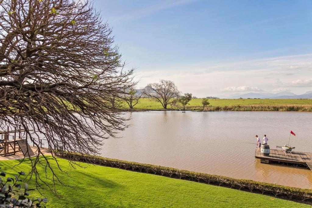 two people on a boat on a river at Waterside on Le Bonheur in Simondium