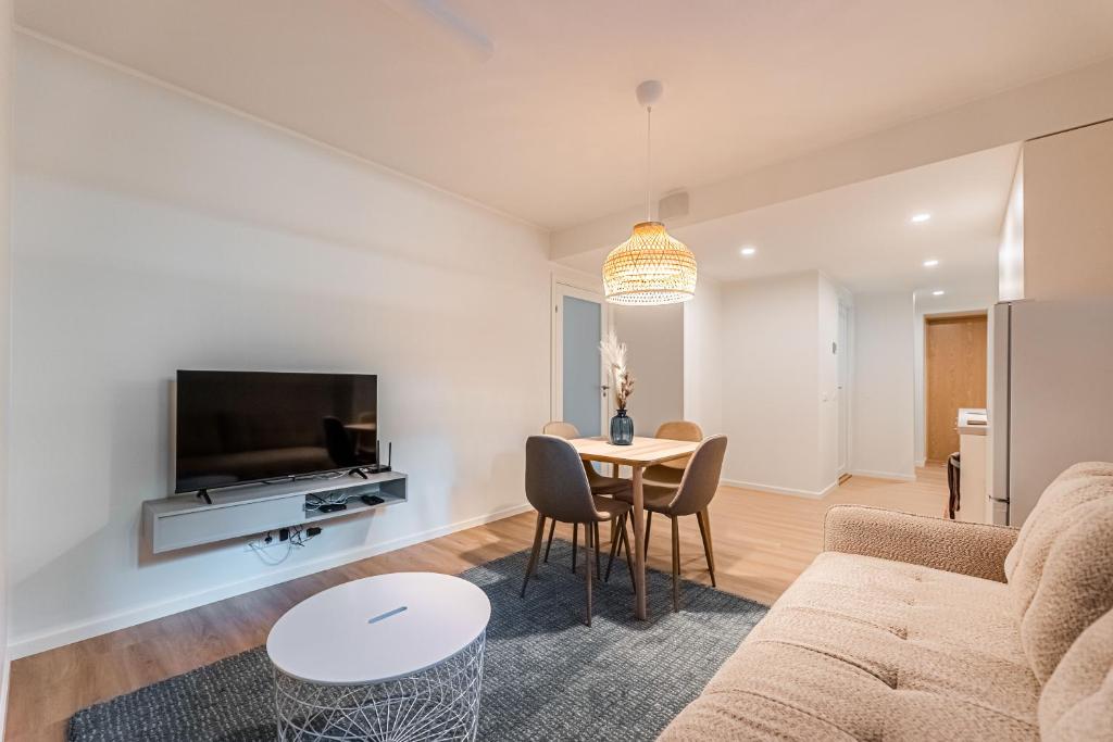 a living room with a couch and a table at Komandandi Smart Stay City Center Apartments in Kuressaare