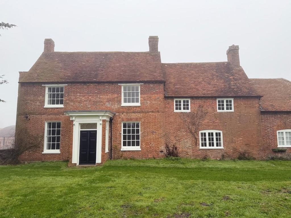 an old red brick house with a green yard at Superb Spacious Farm House in Henley on Thames