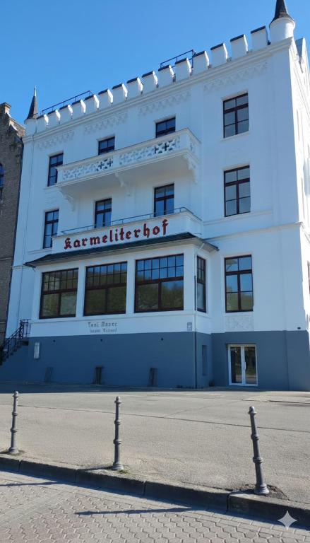 a large white building with a sign on it at Karmeliterhof Studios & Suites in Boppard