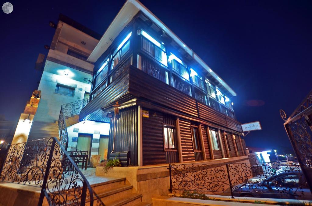 a wooden building with stairs in front of it at night at אחוזת האושר in Tiberias
