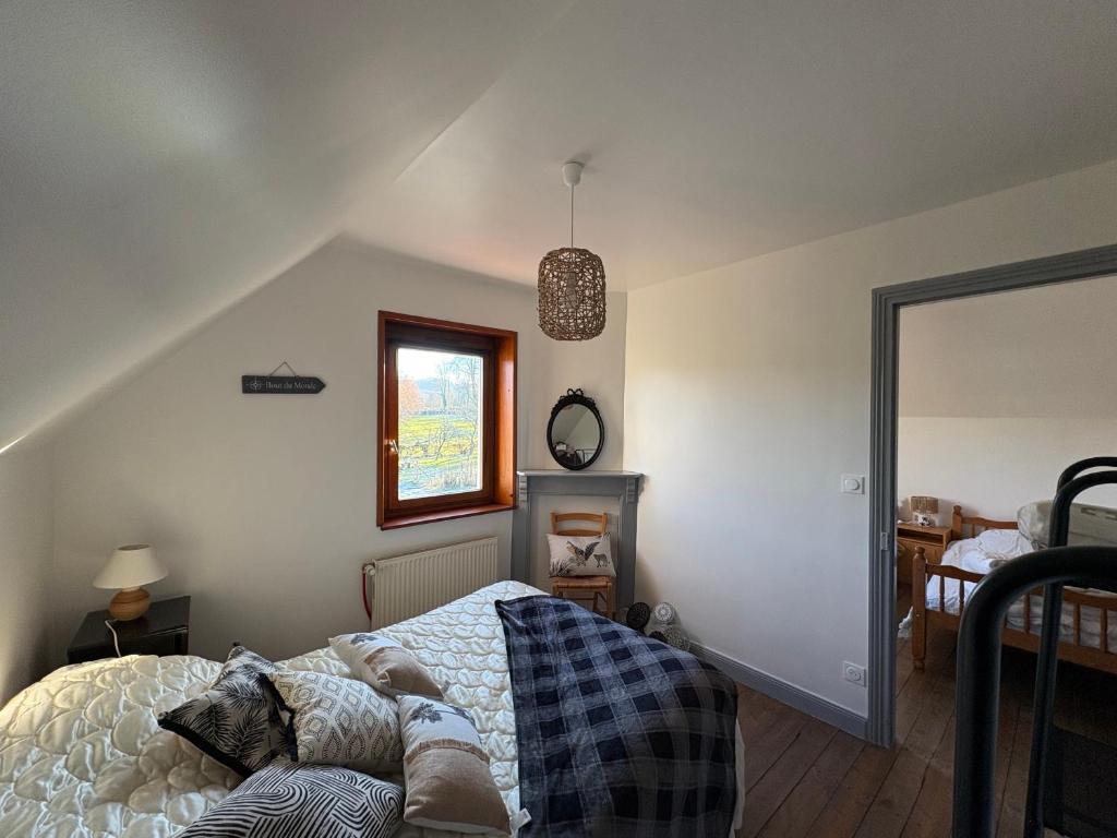 a bedroom with a bed and a mirror at Gîte LA ROUCHERIE bis in Lottinghen