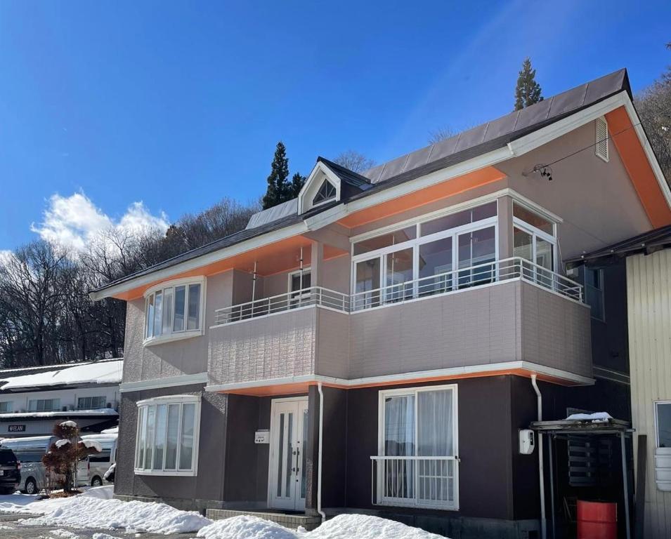 a house with an orange stripe on the side of it at Elan Villa Nojiri in Shinano