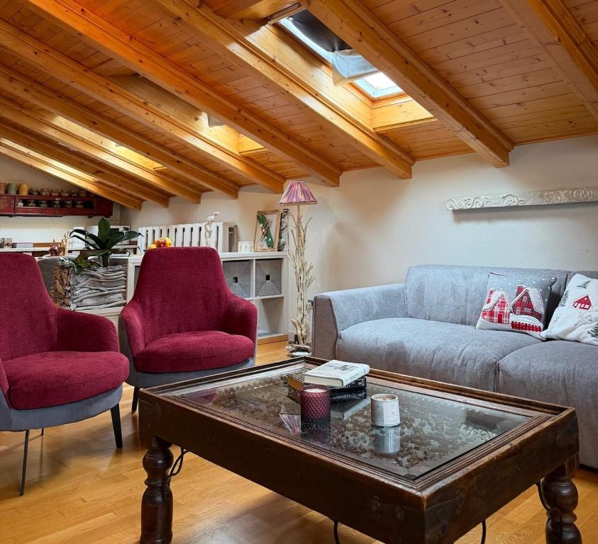 a living room with a couch and two chairs at Bormio Urban Attic in Bormio