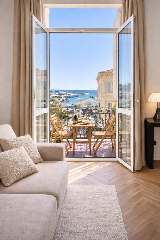 a living room with a couch and a large window at DELUXE SEAVIEW BALCONY - 2 min PALAIS & BEACH in Cannes