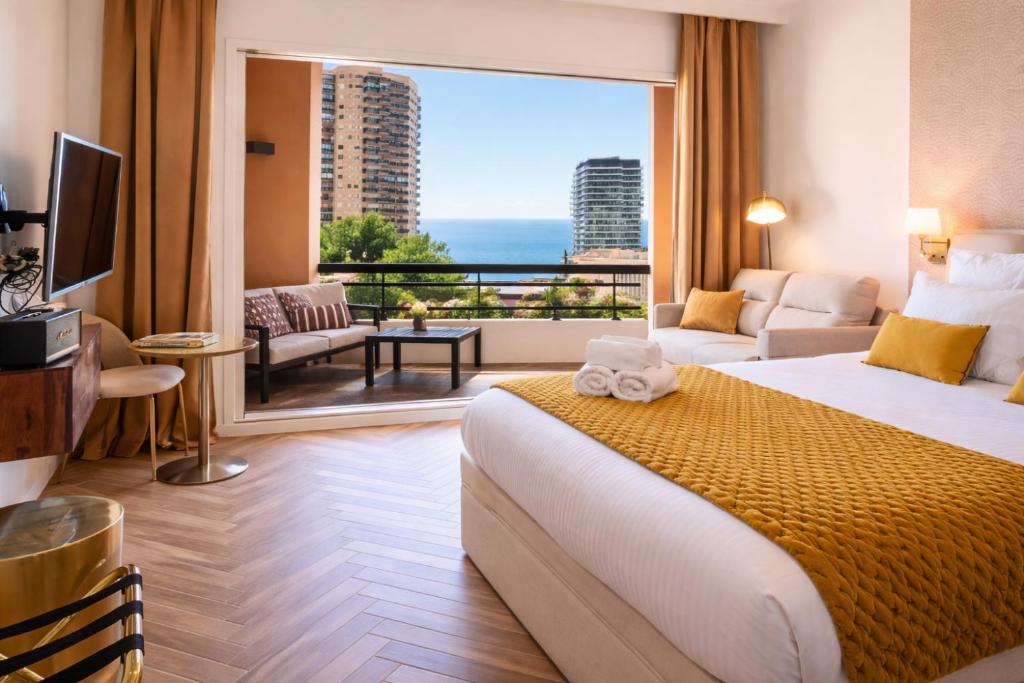 a hotel room with a bed and a large window at Luxury Suite Monaco SeaView Terrace and Pool in Beausoleil