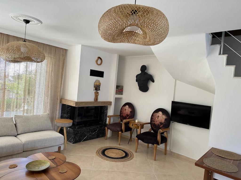 a living room with a couch and a fireplace at Eos in Çeşme