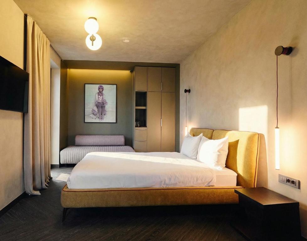 a hotel room with a bed and a chair at Guest House Valea Morilor in Chişinău