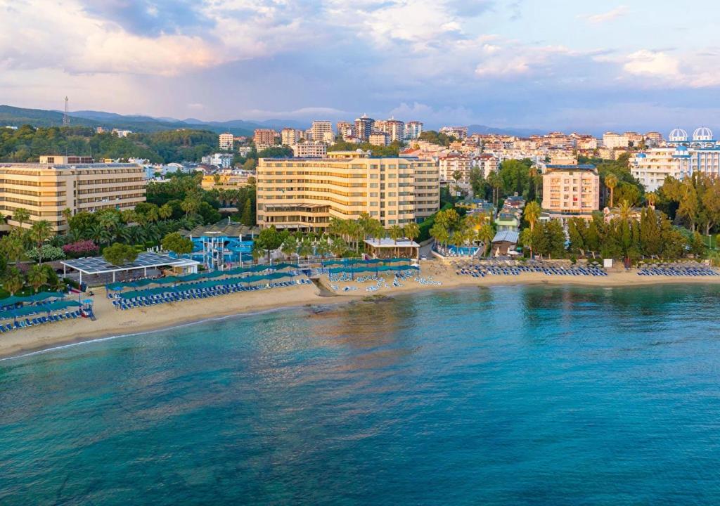 an aerial view of a beach with hotels and buildings at Özkaymak Select Resort Hotel - Ultra All Inclusive in Alanya