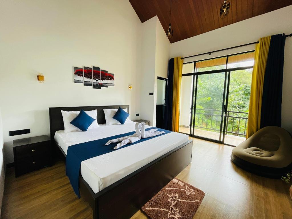 a bedroom with a bed and a large window at Ella White Tea Garden Hotel in Ella