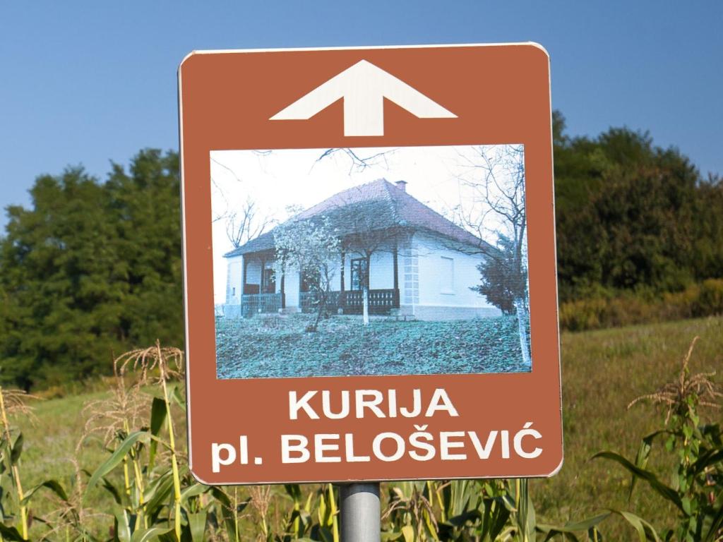 een bord voor een huis in een veld bij Kurija Inn in Hrašćina