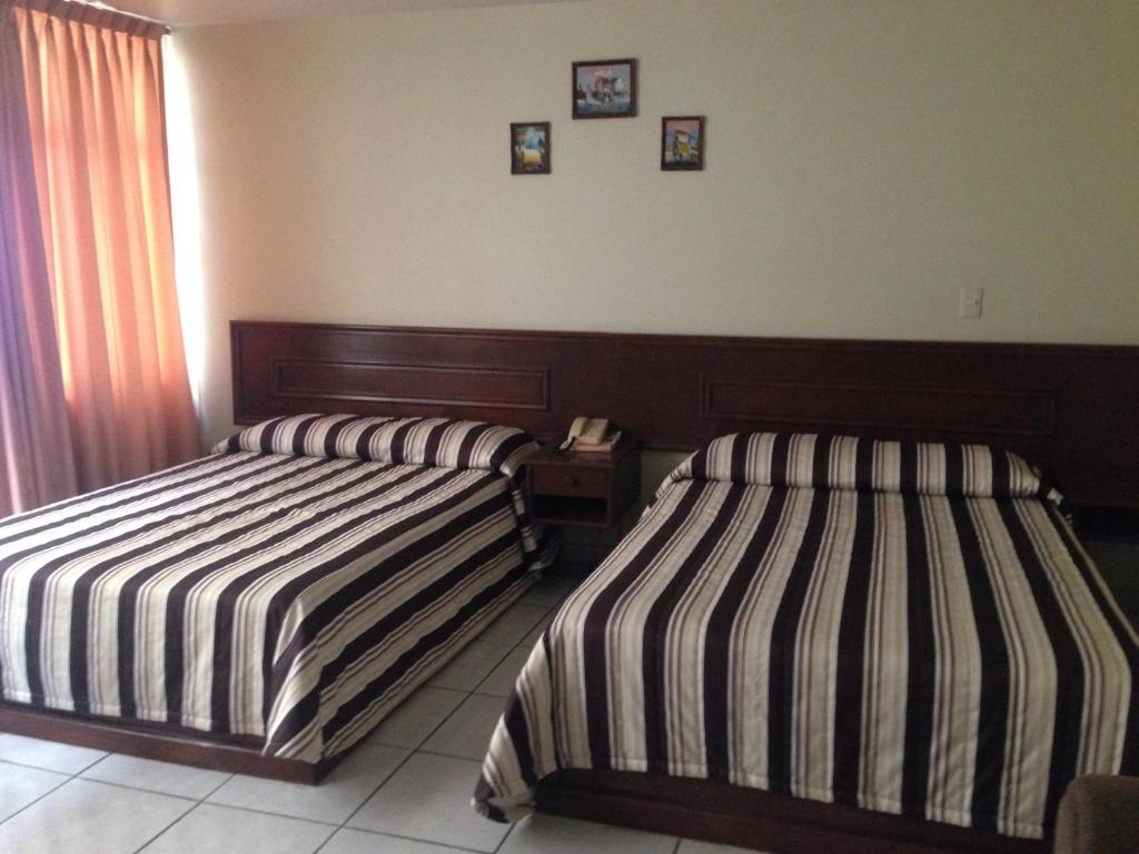 Postel nebo postele na pokoji v ubytování Hotel Plaza Sahuayo