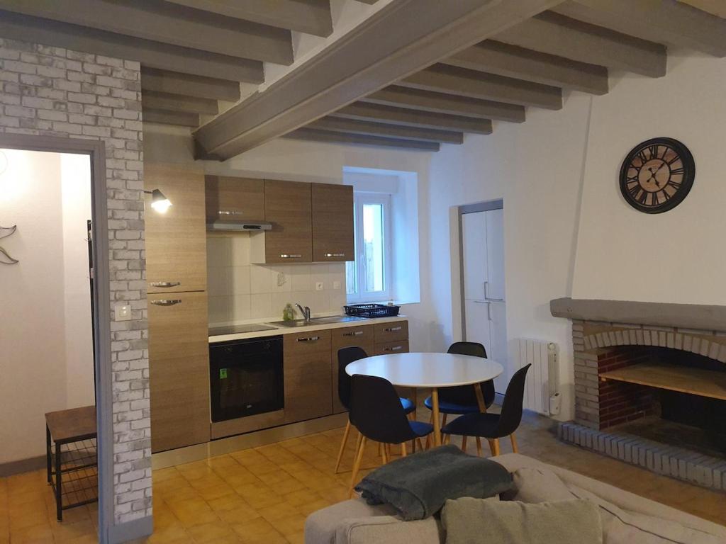 a kitchen and dining room with a table and chairs at Appartement in Noyen-sur-Sarthe
