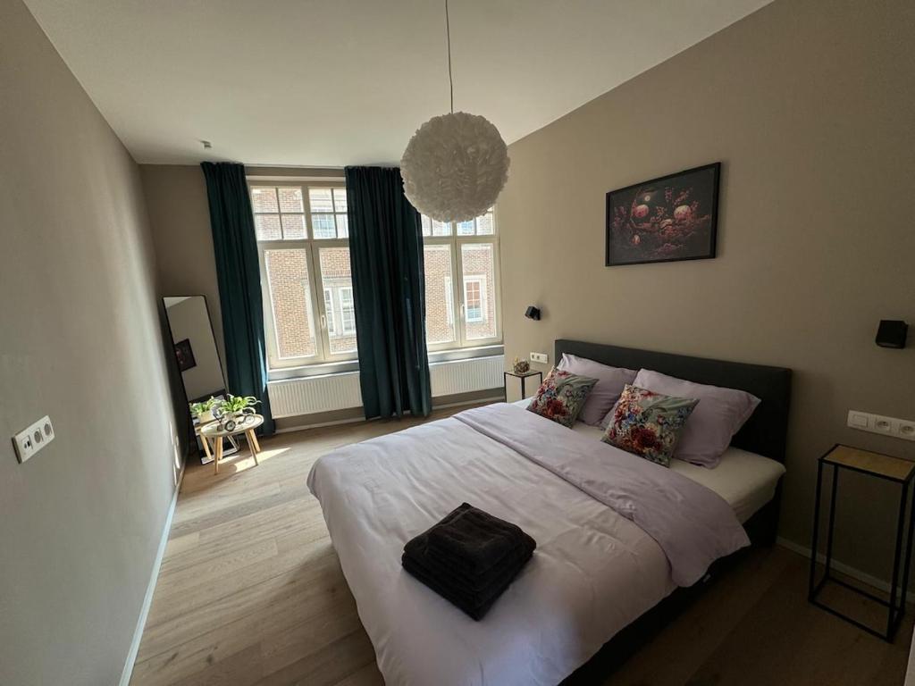 a bedroom with a large bed with white sheets and pillows at Modern apartment - Lier in Lier
