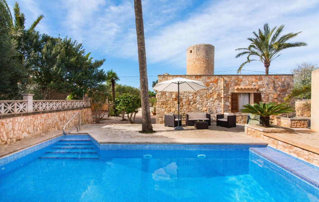 a villa with a swimming pool and a building at Moli De Ca N'orell in Santanyi