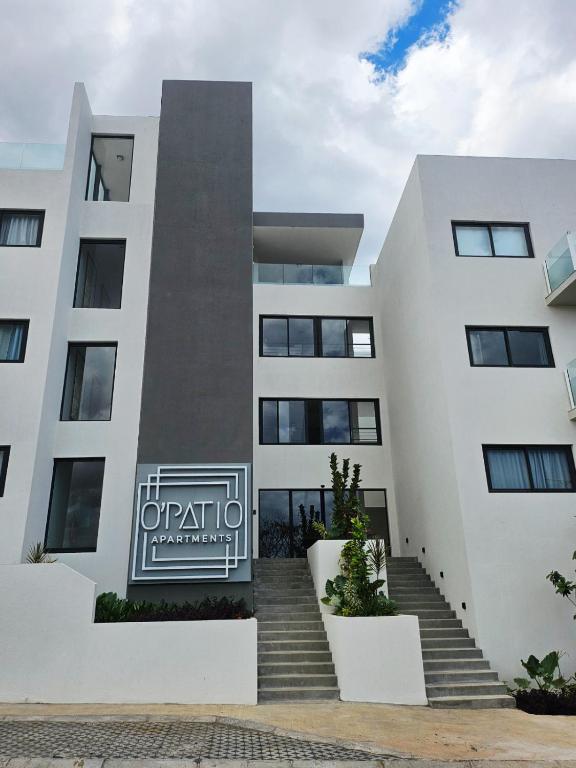a white building with stairs in front of it at Friendly & Warm in Tamarin