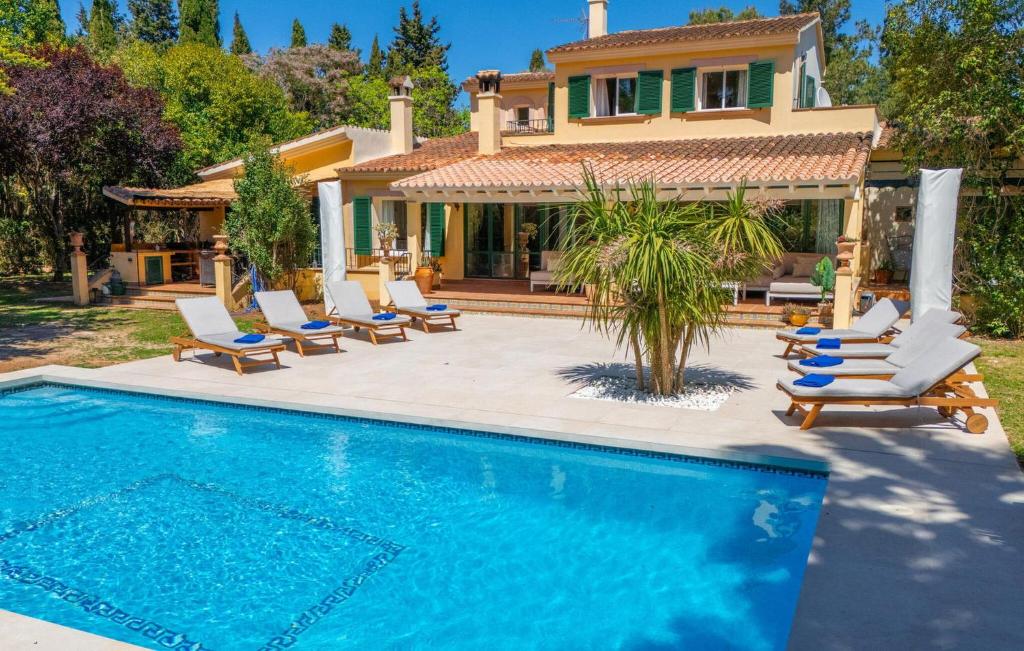 a villa with a swimming pool in front of a house at Casa Maria in Santa Maria del Camí