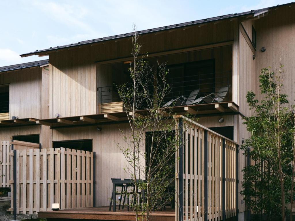a house with a balcony and a table on a porch at GEOSPOT Motohakone C 2026年1月 New Open in Hakone