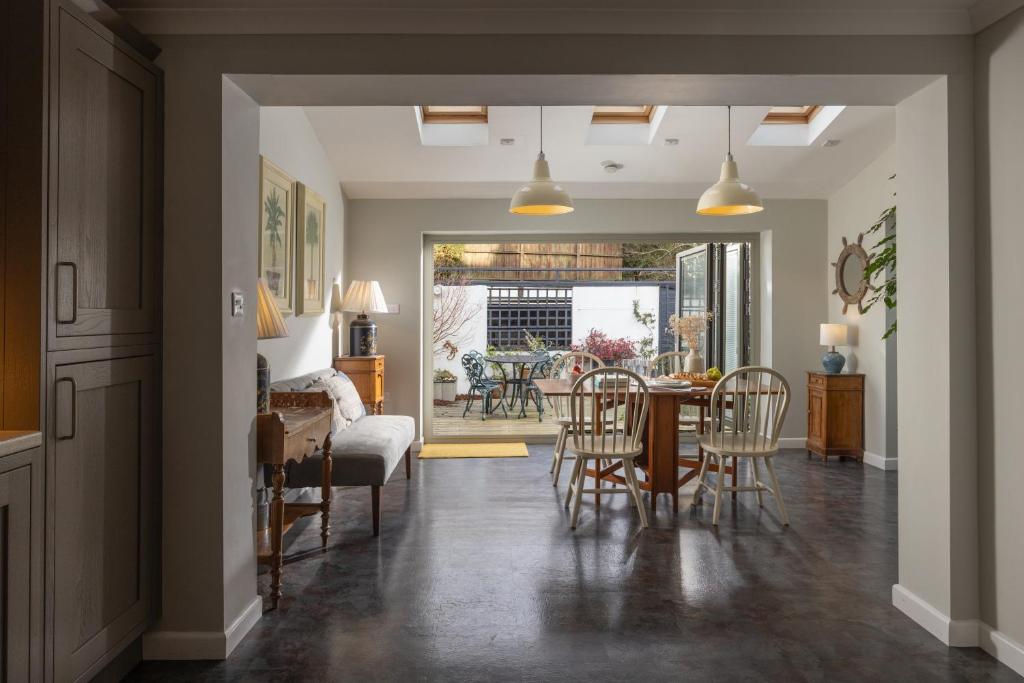 a dining room and living room with a table and chairs at Easy Oars - Flushing, Falmouth in Flushing