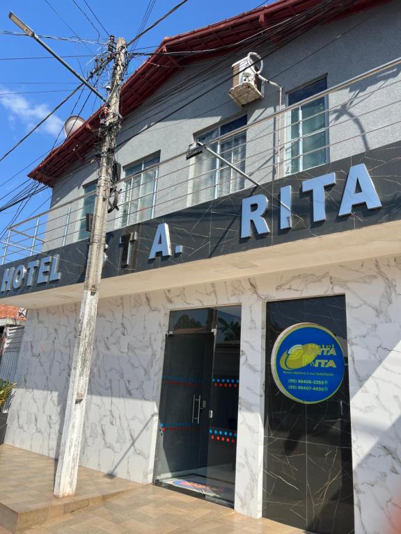 a building with a raica sign on the side of it at Hotel Santa Rita in Amarante do Maranhão