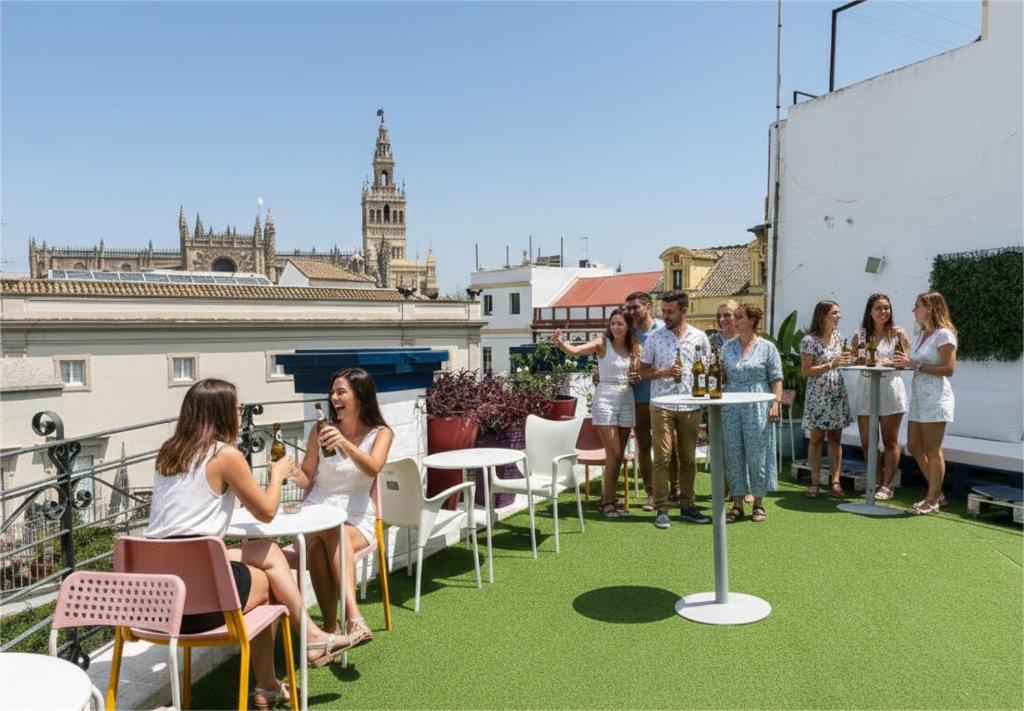a group of people sitting at tables on a roof at Rio Hostel in Seville