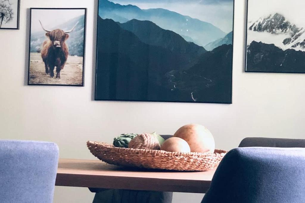 a table with a bowl of eggs and a picture of a bull at Wanderlust Chiemgau in Bad Endorf