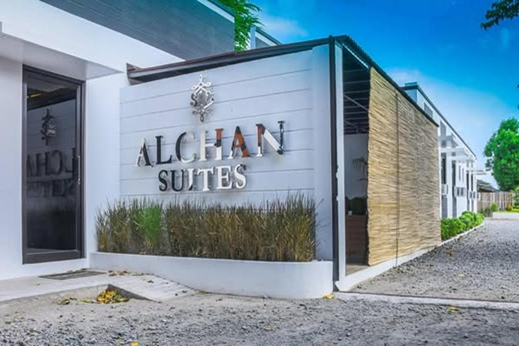 a store with a sign on the side of a building at Alchan Suites in General Santos