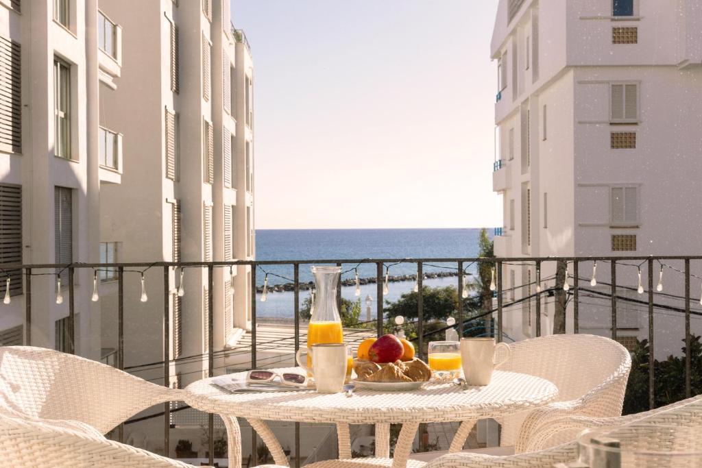 a table with a plate of food on a balcony at Casa LoIa Altea By DelucaCo in Altea
