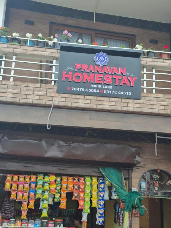 a sign for aryan homesay on top of a store at Pranavan Homestay in Mirik