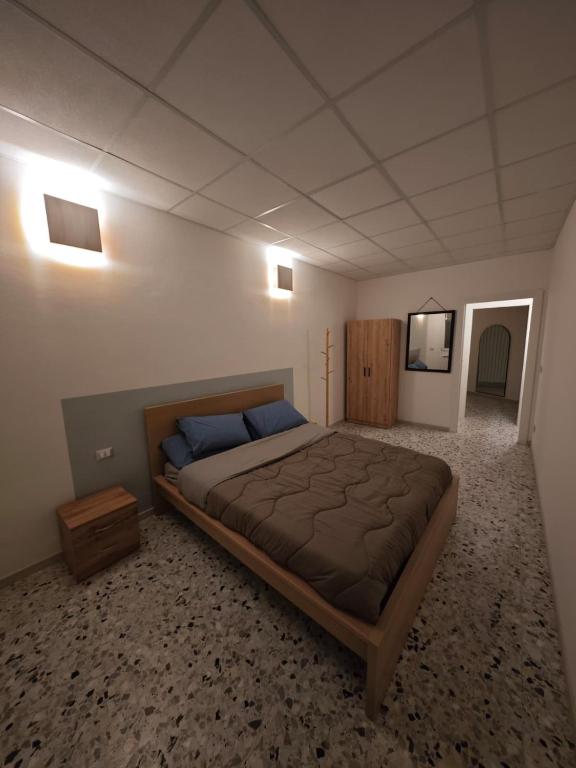 a bedroom with a large bed and a television at Arlecchino Rooms in Santa Maria Codifiume