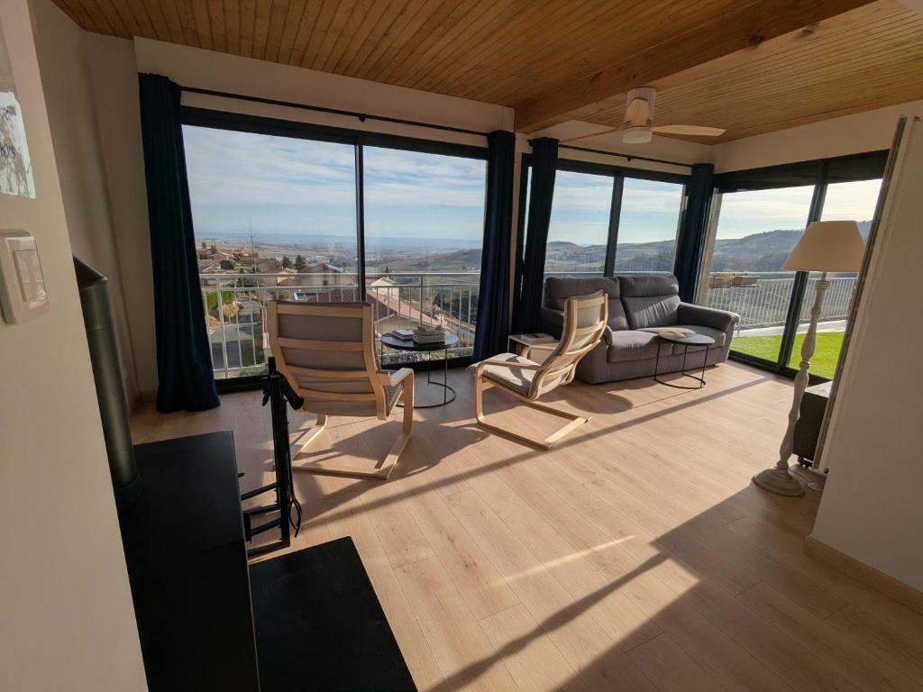 a living room with a view of the city at Gîte du Vieux Cuvage in Vaux-en-Beaujolais