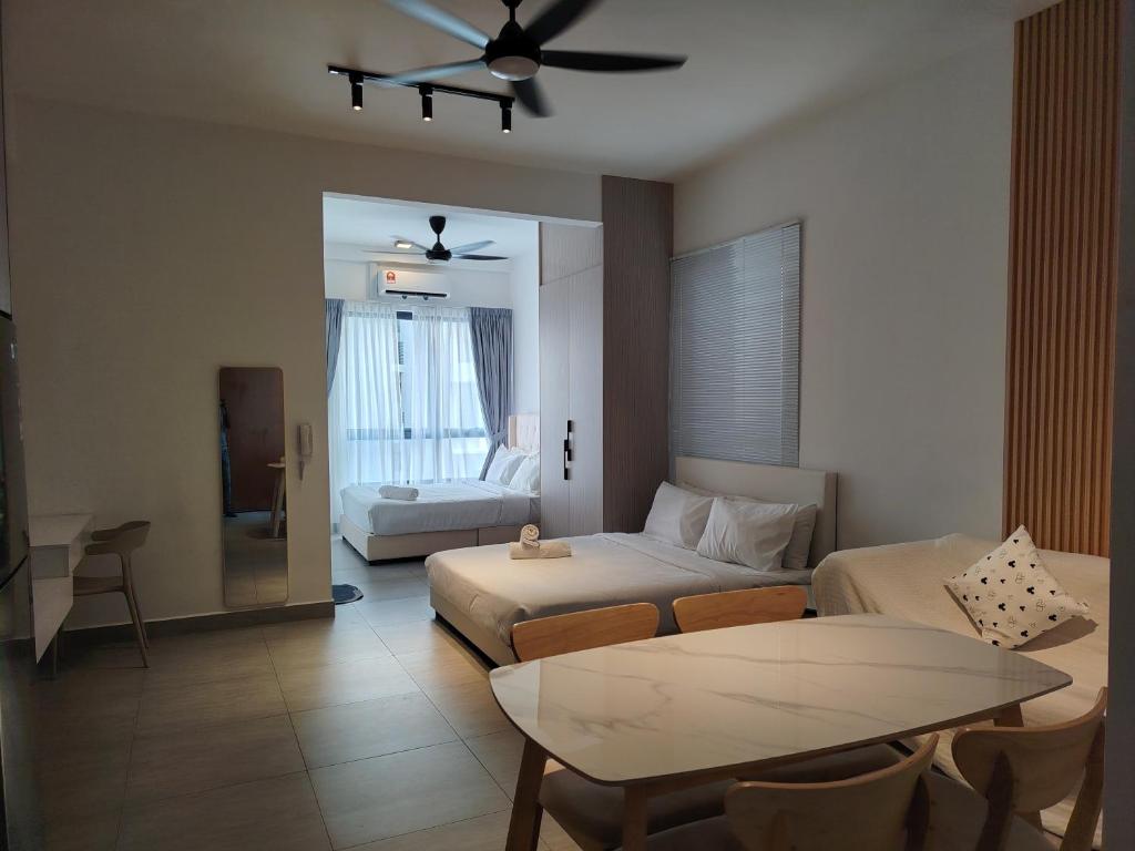 a living room with a bed and a couch at Sunsuria Forum Soho by Diamond in Shah Alam
