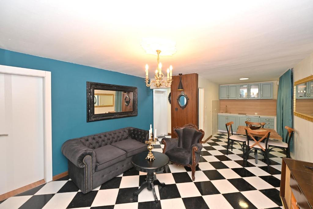 a living room with a couch and chairs at Two bedroom Vintage apartment in Kotor
