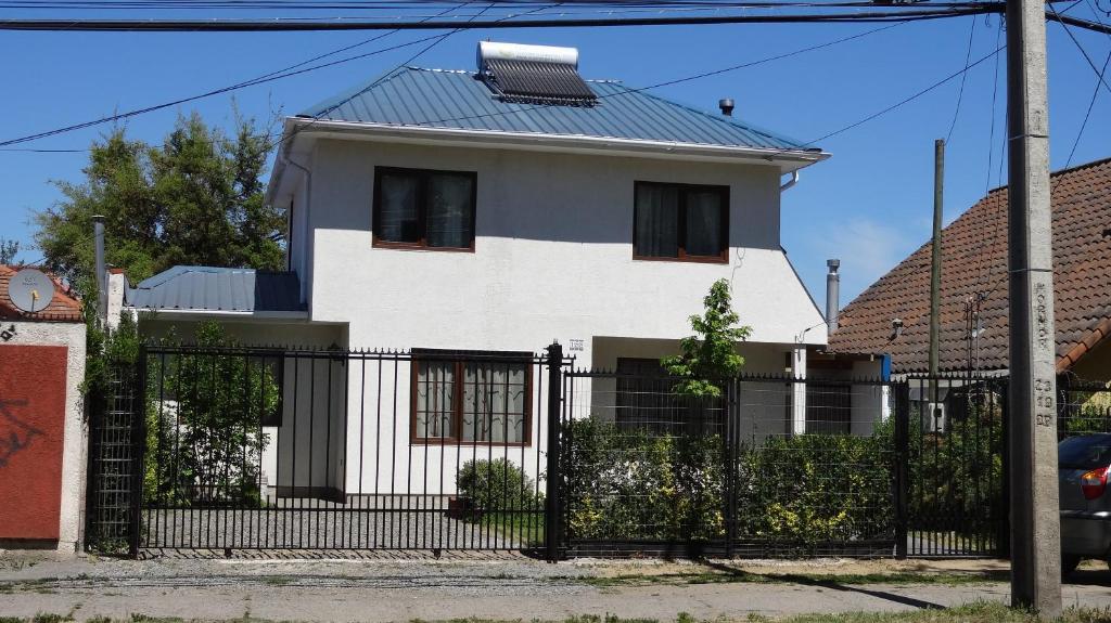 a white house with a black fence at Tralka B&B in Talca