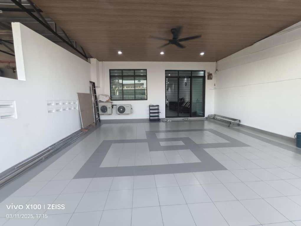 a large room with a ceiling fan and a white floor at Easy stay kk in Kota Kinabalu