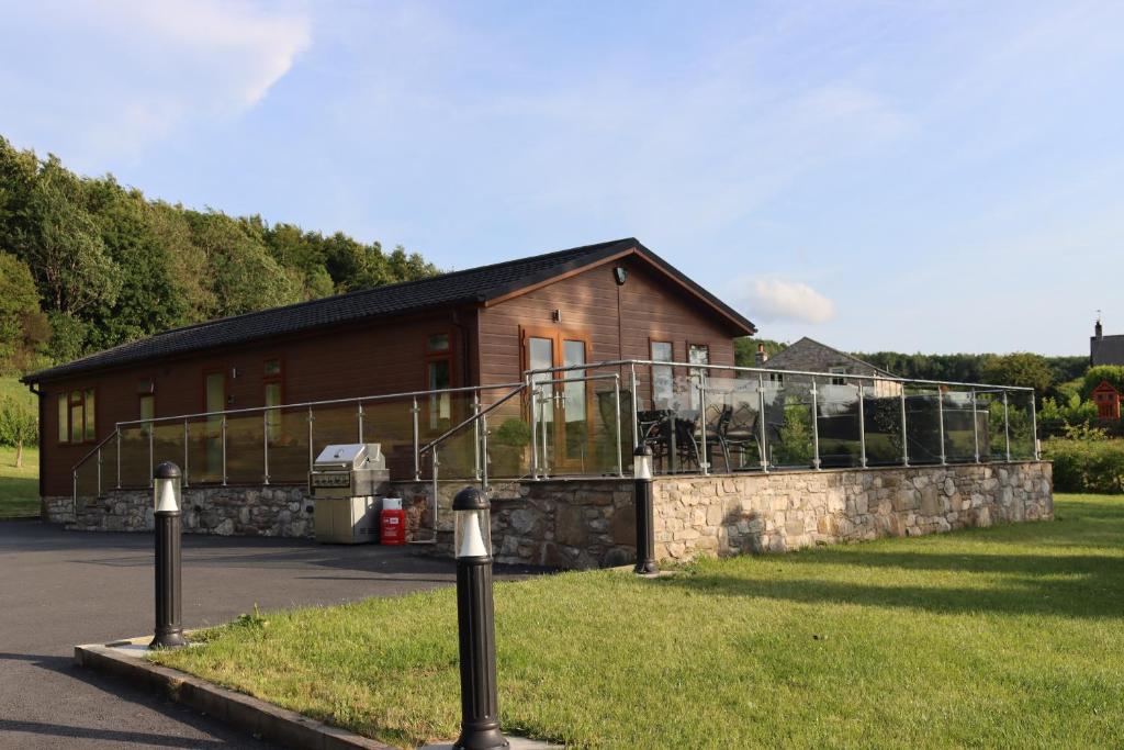 a house with a balcony on the side of it at Holly Lodge in Holywell