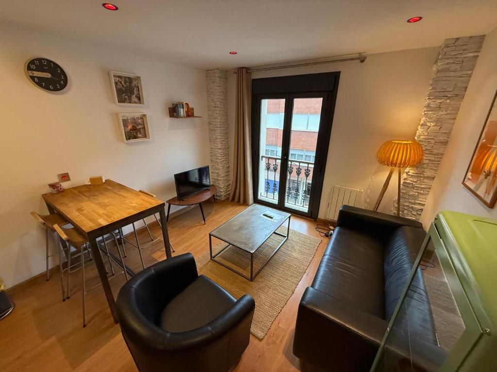 a living room with a couch and a table at Lotila Flats Cabañaquinta in Aller