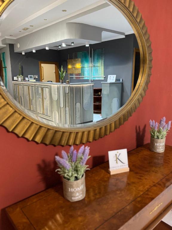 a mirror on the wall of a restaurant at Kornilios Istron Hotel in Giannitsa