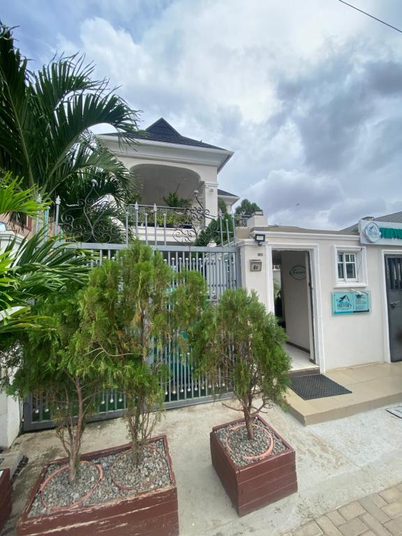 a white house with trees in front of it at Trevors Home Place in Lagos