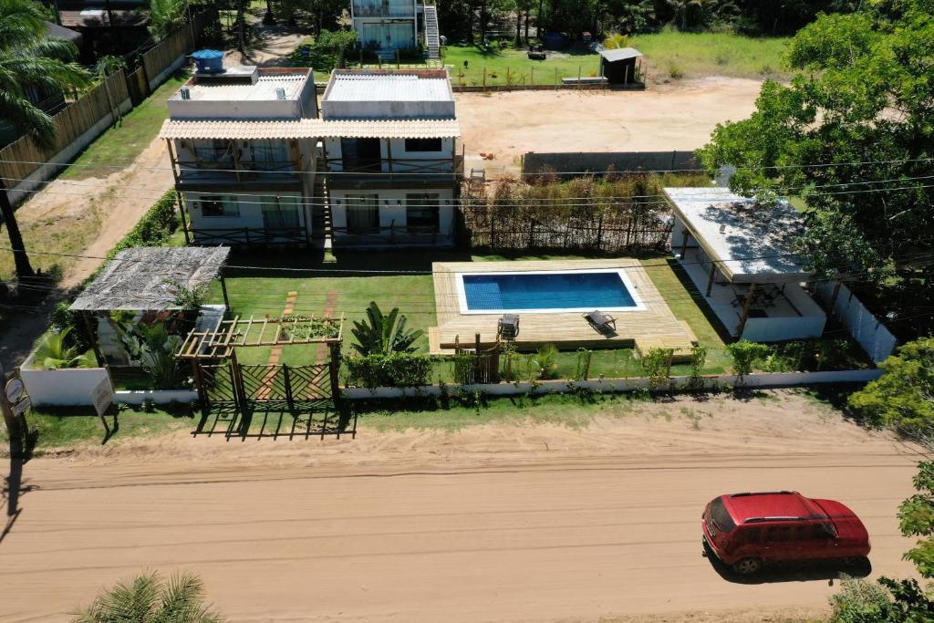 a red car parked in front of a house at Recanto dos Coraiss in Marau