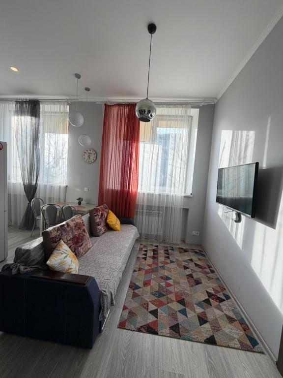 a living room with a couch and a flat screen tv at Центр.Леся Українка in Lutsk