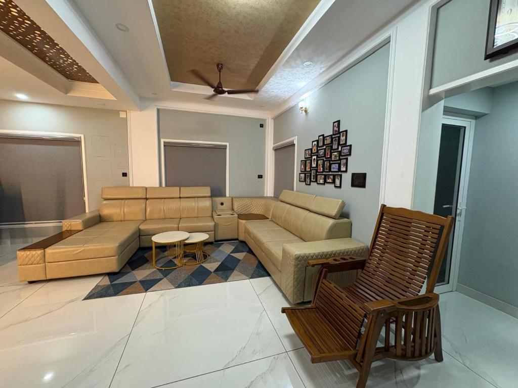 a living room with a couch and a table at Evania Pool Suites in Nedumbassery
