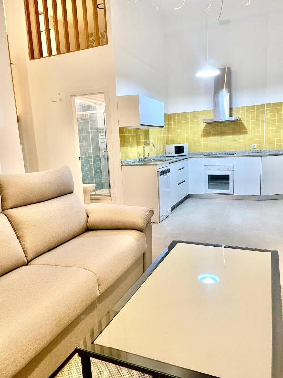 a living room with a couch and a table at Loft Manuel Arellano in Seville