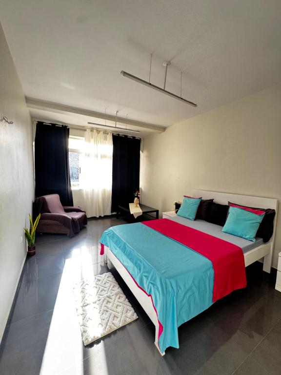 a bedroom with a large bed and a couch at Cozy Home with Terrace Views! in Ponta do Sol