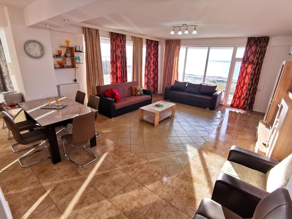 a living room with a couch and a table at Elisa Summerland Apartment in Mamaia