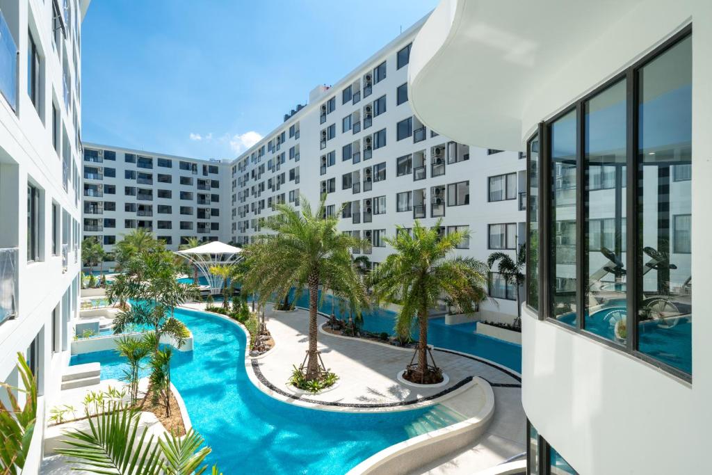 an apartment with a swimming pool in a building at Capri Residence Bangtao in Bang Tao Beach